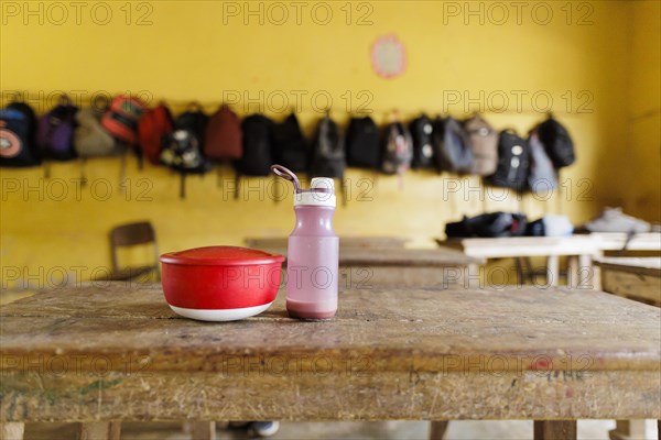 Subject: Schoolchildren in Africa. Drinking bottle and eating utensils on a table, Krokrobite, Ghana, Africa