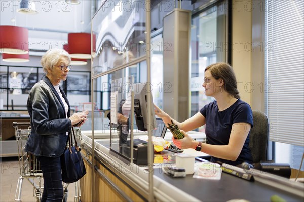 Elderly woman shopping in the supermarket. Radevormwald, Germany, Europe