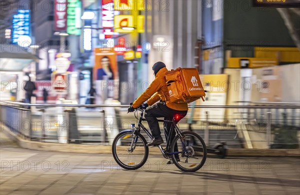 Bike courier from Lieferando on the road with bike, Rider, Stuttgart, Baden-Wuerttemberg, Germany, Europe