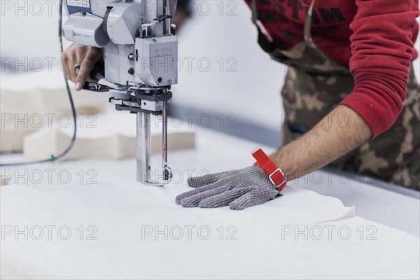 A worker cuts fabric at the Afrasyab jeans factory in Samarkand, 02.11.2022., Samarkand, Uzbekistan, Asia