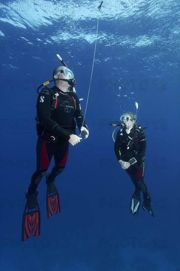 Diver, diver, exercise, setting the safety buoy, 4. When the buoy is filled with air, immediately let it rise on the rope to the surface of the water, Red Sea, Hurghada, Egypt, Africa