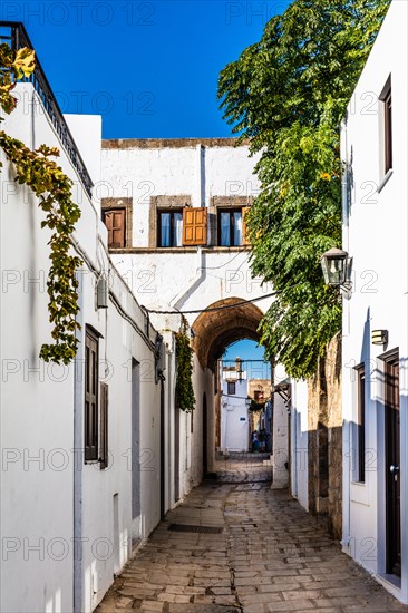 Captains house in the winding streets with white houses, Lindos, Rhodes, Greece, Europe