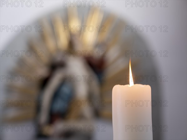 Burning candle in front of a Pieta in the Catholic parish church of St. Peter and Paul, former collegiate church, Romanesque columned basilica, Unesco World Heritage Site, Niederzell on the island of Reichenau in Lake Constance, Constance district, Baden-Wuerttemberg, Germany, Europe