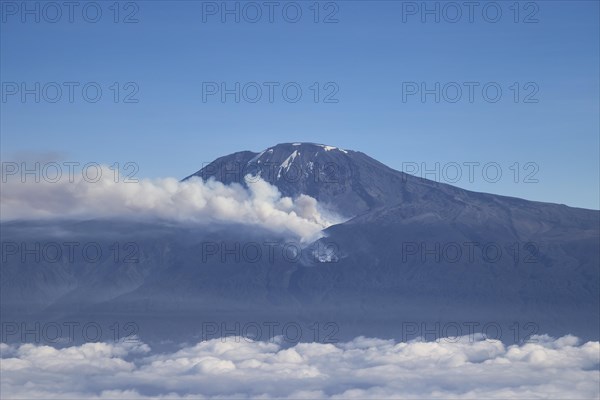 Aerial view, mountain peak of Kilimanjaro volcano with forest fire and smoke on the mountain flank, Tanzania, East Africa, Africa