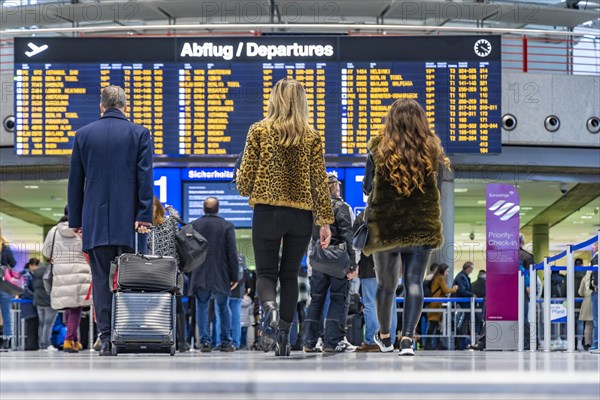 Airport terminal with departure indicator board, departure, travellers with suitcases, interior shot, Airport Echterdingen, Stuttgart, Baden-Wuerttemberg, Germany, Europe