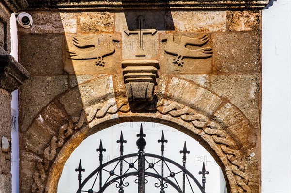 Old wooden doors with pebble mosaics on the floor, winding streets with white houses, Lindos, Rhodes, Greece, Europe