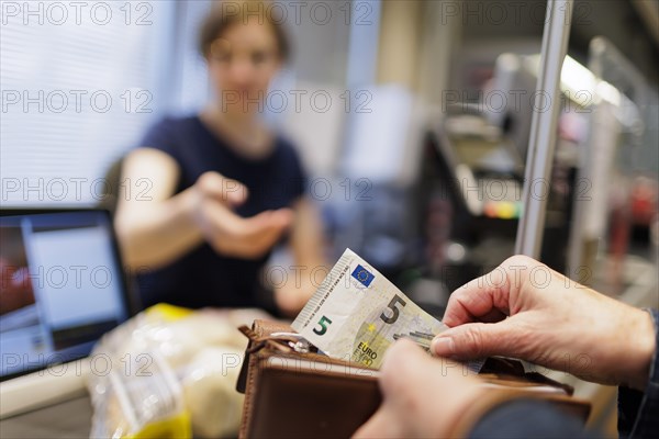 Cash payment at the supermarket. Radevormwald, Germany, Europe