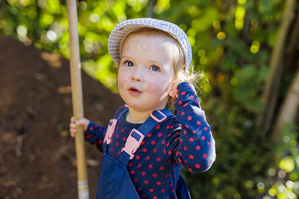 Portait of a toddler, with a shovel., Bonn, Germany, Europe