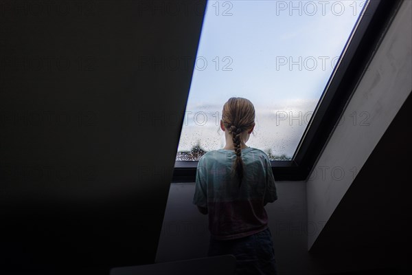 Girl looking out of the window, Bonn, Germany, Europe