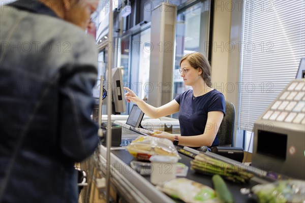 Cashier in a supermarket. Radevormwald, Germany, Europe