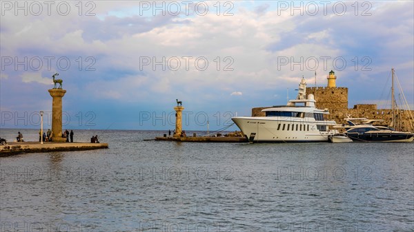 Mandraki harbour, harbour entrance with columns with stag and hind, site of the Colossus of Rhodes, Rhodes Town, Greece, Europe