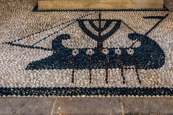 Old wooden doors with pebble mosaics on the floor, winding streets with white houses, Lindos, Rhodes, Greece, Europe