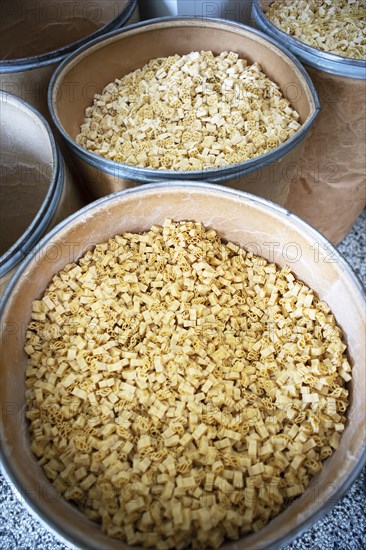 Noodles in a storage bin, Finkensteiner Nudelfabrik, Finkenstein am Faaker See, Villach region, Carinthia, Austria, Europe