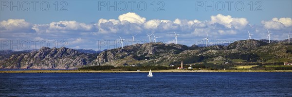 North Sea with coastal landscape, sailboat and Lista fyr lighthouse, Lista peninsula, Steinodden, Norway, Europe