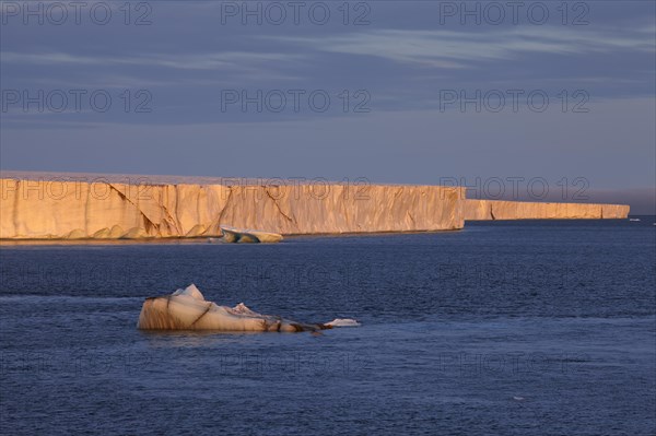 Brasvellbreen coastal glacier, glacier front in the evening light at sunset, ice chunks floating in front of it, Nordaustlandet, Svalbard