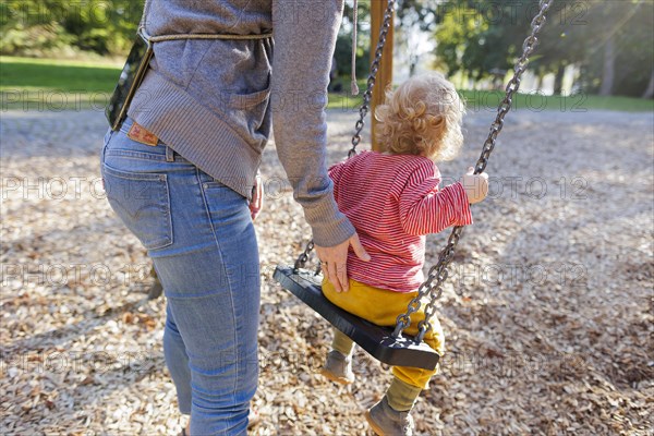 Child on a swing. Bonn, Germany, Europe