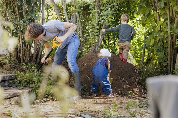 Father and two children working in the garden, Bonn, Germany, Europe