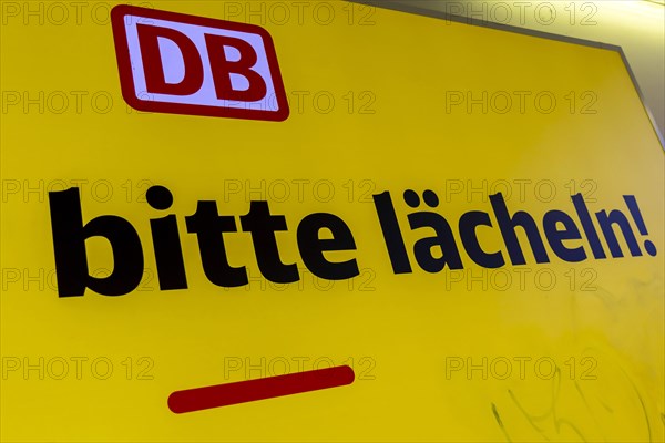 Campaign for friendliness by Deutsche Bahn AG. Smile from here please, symbol photo. Illuminated poster in Heilbronn main station, Baden-Wuerttemberg, Germany, Europe