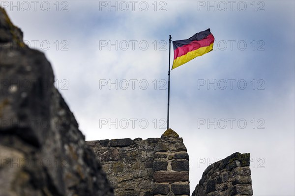 German flag of the town fortification from the 13th century, with town wall, battlements and witchs tower, Hillesheim, Rhineland-Palatinate, Germany, Europe