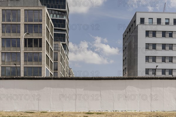 The Berlin Wall looms in front of newly built houses at the East Side Gallery in Berlin, 26.06.2022., Berlin, Germany, Europe