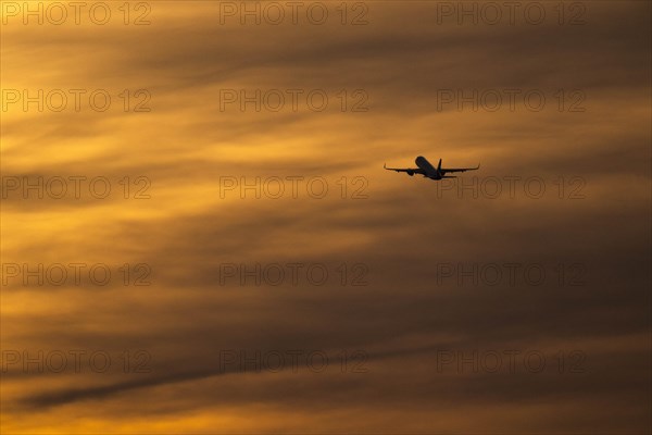 An aeroplane stands out in front of dusk at the capitals airport BER in Berlin, 09.02.2023., Berlin, Germany, Europe