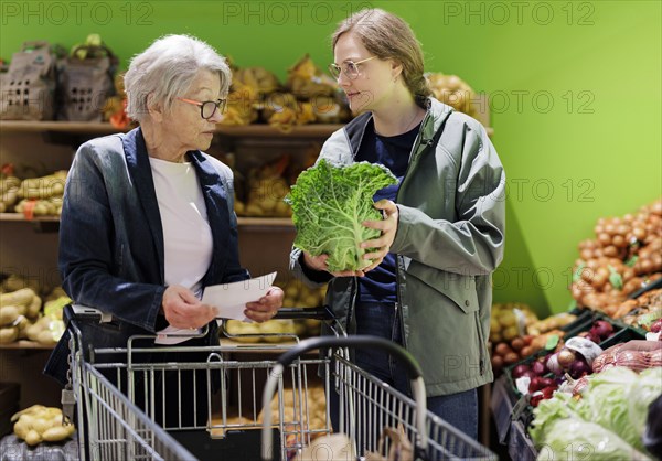 Elderly woman shopping in supermarket, Radevormwald, Germany, Europe