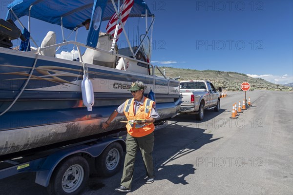 Gunnison, Colorado, Carol Soell, a boat inspector at Curecanti National Recreation Area, checks boats entering and leaving Blue Mesa Reservoir for invasive species. Colorados mandatory inspection program aims to keep zebra and quagga mussels, New Zealand mudsnails, Eurasian Watermilfoil, rusty crayfish, and waterfleas out of the states waters