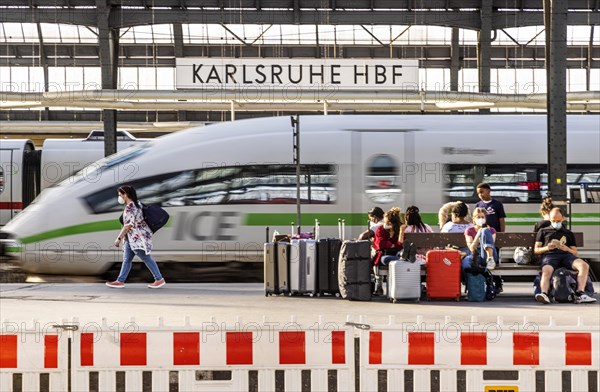 Main station with station sign, platform and InterCityExpress ICE of Deutsche Bahn, Karlsruhe, Baden-Wuerttemberg, Germany, Europe