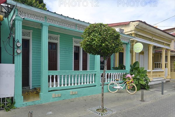 Colonial houses with bicycle in Centro Historico, Old Town of Puerto Plata, Dominican Republic, Caribbean, Central America