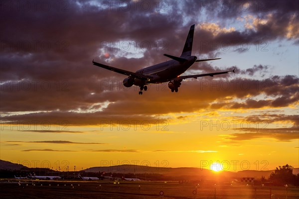 Airport ZRH with aircraft on approach of the airline Swiss, Airbus A320-200, sunset, Zurich, Switzerland, Europe