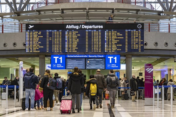 Airport terminal with departure indicator board, departure, travellers with suitcases, interior shot, Airport Echterdingen, Stuttgart, Baden-Wuerttemberg, Germany, Europe