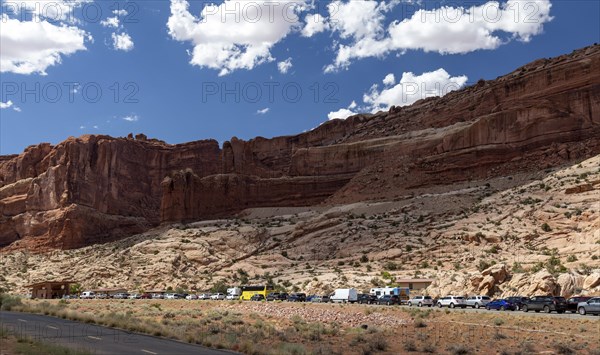 Moab, Utah, A long line of cars waiting to enter Arches National Park on a summer afternoon. The National Park Service is experimenting by requiring timed reservations in order to control the crowds