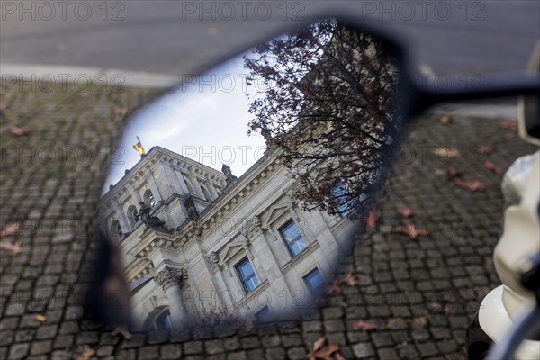 Part of the building of the German Bundestag can be seen in a motorbike mirror. Berlin, Berlin, Germany, Europe