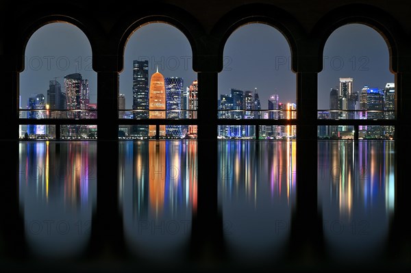 View of the illuminated skyline of Doha, Qatar, from the terrace of the Museum of Islamic Art by the archtics Ieoh Ming Pei and Jean-Michel Wilmotte, Asia