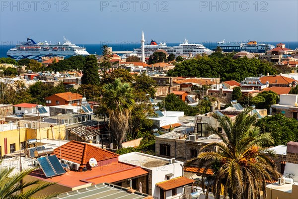 View over the old town to Mandraki harbour with cruise ships, Rhodes Town, Greece, Europe