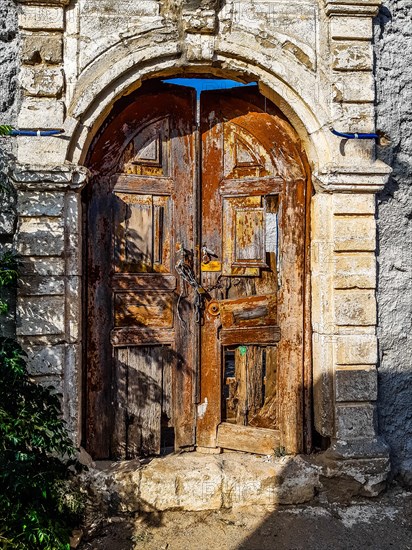 Old wooden doors with pebble mosaics on the floor, winding streets with white houses, Lindos, Rhodes, Greece, Europe