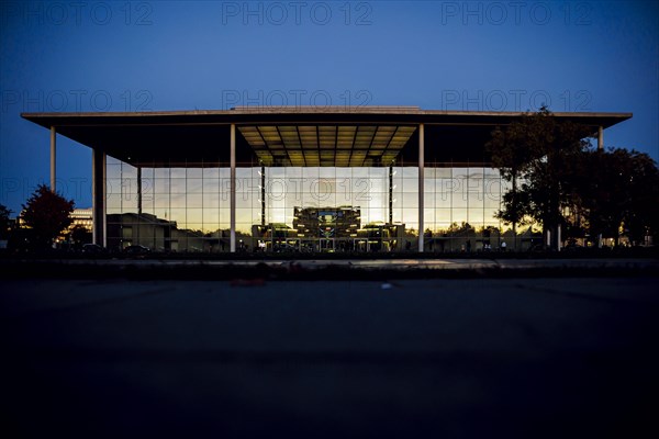 The evening sky and the Federal Chancellery are reflected in the windows of the Paul Loebe Building. Berlin, Berlin, Germany, Europe