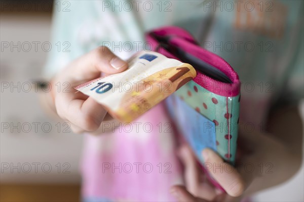 Ten-year-old girl and pocket money, Bonn, Germany, Europe