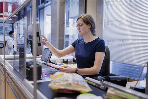 Cashier in a supermarket. Radevormwald, Germany, Europe