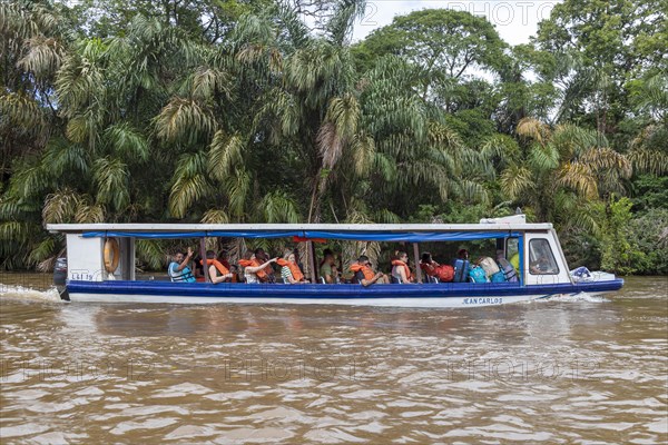 La Pavona, Costa Rica, Tourists ride boats on the Suerte River for the hour-long ride to Tortuguero National Park, Central America