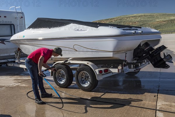 Evanston, Wyoming, An employee of the Wyoming Game & Fish Department inspects and decontaminates watercraft at a mandatory inspection station along the Utah border. The intent is to keep invasive aquatic species, including zebra mussels and quagga mussels, out of the states waters