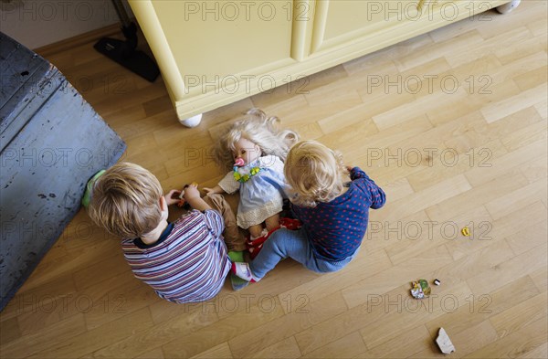 Bonn. Toddler playing on the floor in the living room. Bonn, Germany, Europe