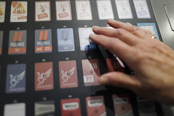 Buying cigarettes in the supermarket. Radevormwald, Germany, Europe