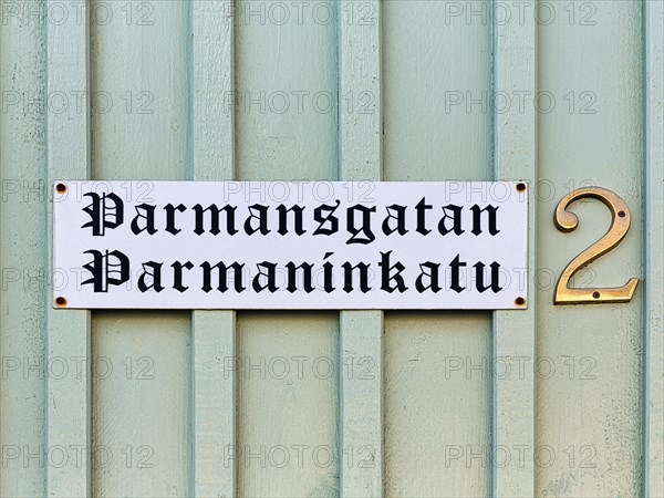 Bilingual street sign on wooden facade, wooden house, street name Parmansgatan in Swedish and Finnish, house number 2, Old Town of Kristinestad, Kristiinankaupunki, Oesterbotten, Finland, Europe