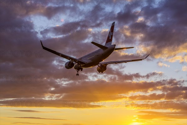 ZRH Airport with aircraft on approach of the airline Swiss, Bombardier BD-500, sunset, Zurich, Switzerland, Europe