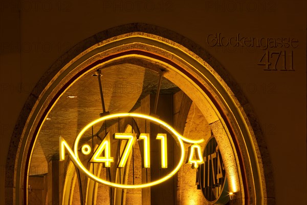 Illuminated 4711 logo, new logo version from 2011 and house number on the main building in Glockengasse in the evening, Cologne, North Rhine-Westphalia, Germany, Europe