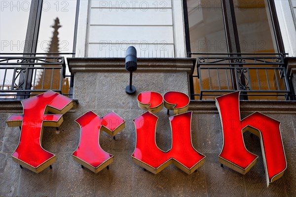 Letters of the Frueh Brewery with reflection of the cathedral spire in the window, Old Town, Cologne, Rhineland, North Rhine-Westphalia, Germany, Europe