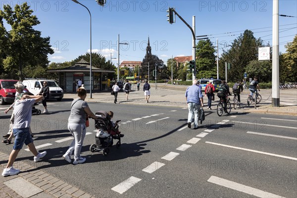 Pedestrian traffic lights at Albertplatz in Dresden during rush hour, in the background the Dreikoenigskirche, Dresden, Saxony, Germany, Europe