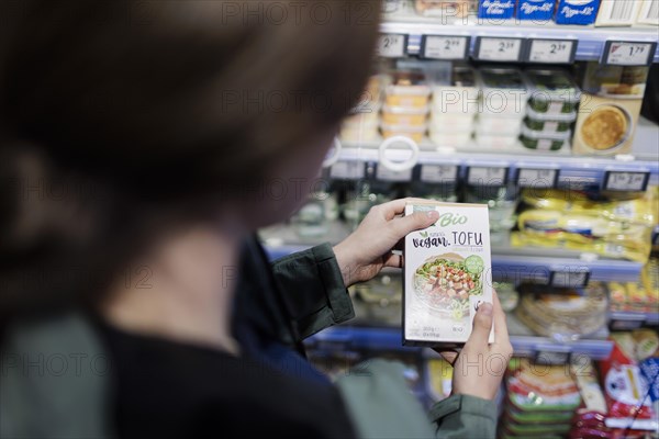 Elderly woman shopping in supermarket, Radevormwald, Germany, Europe