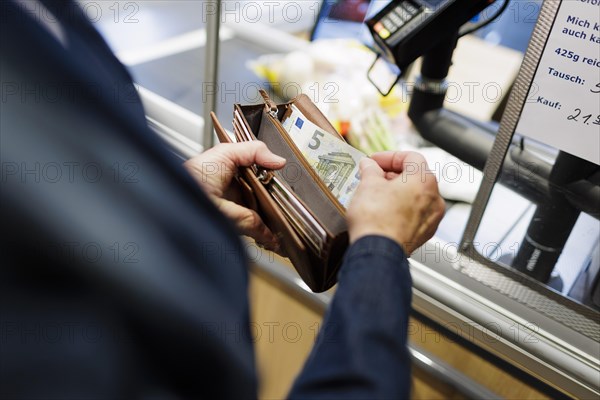 Cash payment at the supermarket. Radevormwald, Germany, Europe